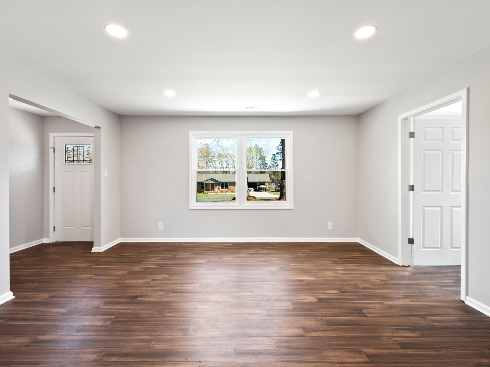 1813 Timber Ln Drive Monroe, NC 28110 - Photo 30 of 35 an empty room with wooden floor and windows