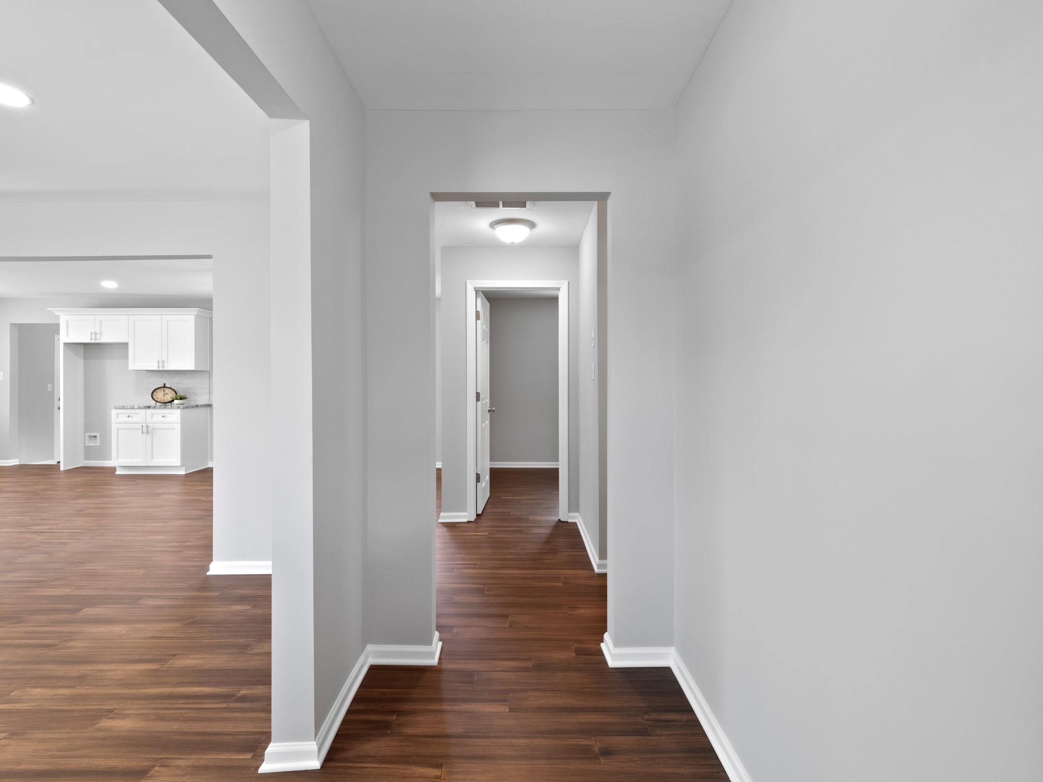 1813 Timber Ln Drive Monroe, NC 28110 - Photo 32 of 35 a view of a hallway with wooden floor and a bathroom