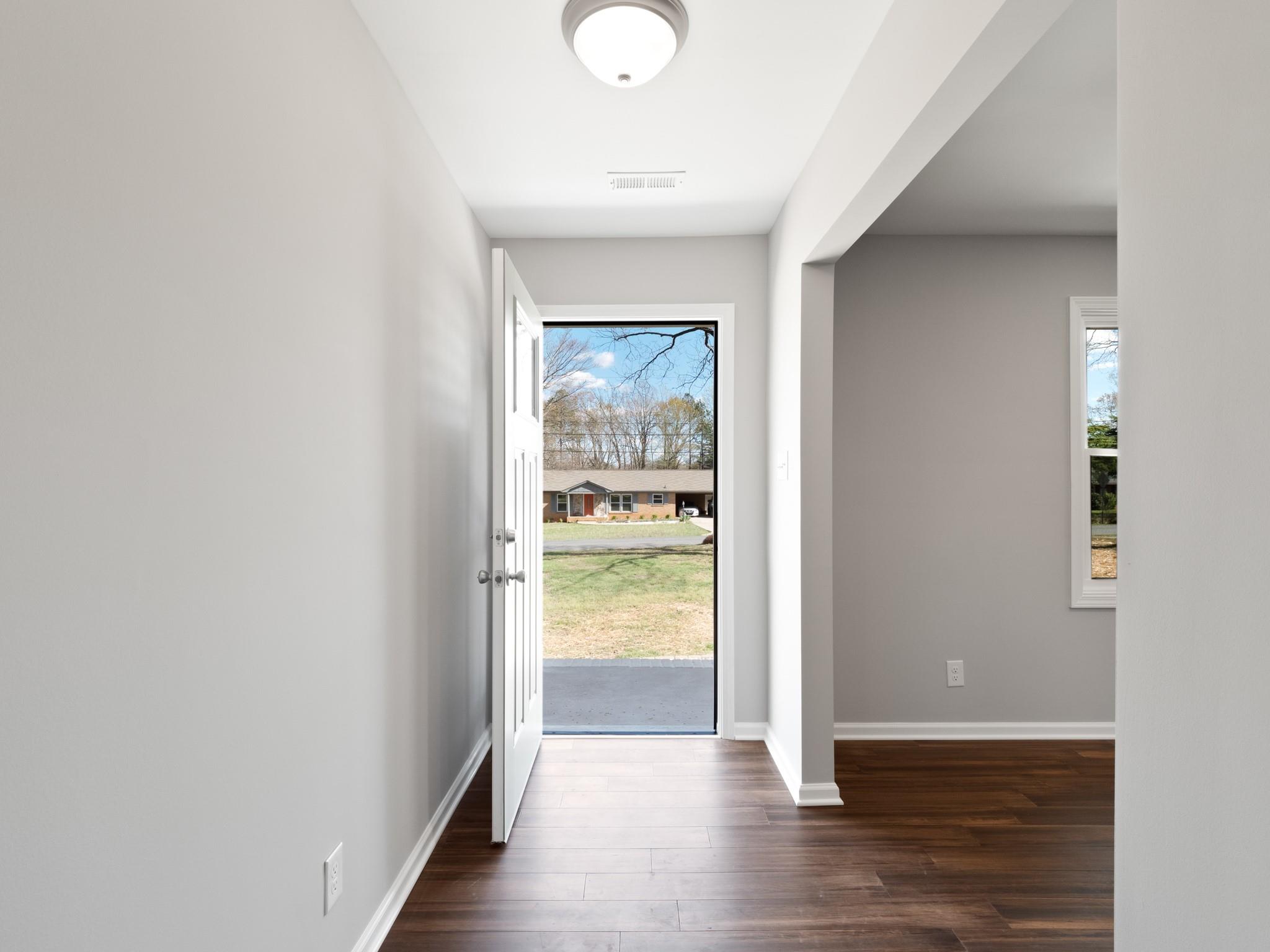 1813 Timber Ln Drive Monroe, NC 28110 - Photo 33 of 35 a view of a hallway with wooden floor and a bathroom