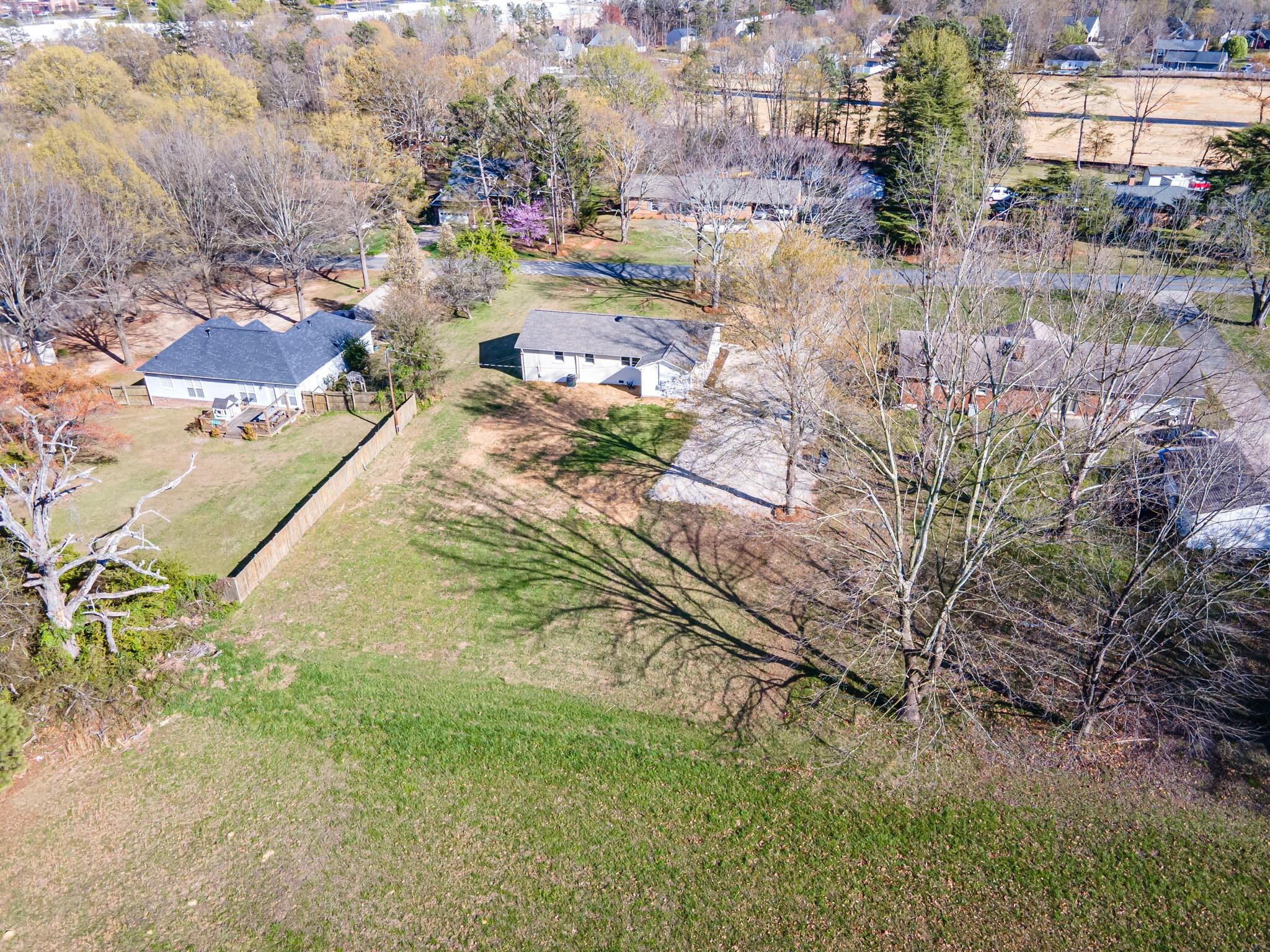 1813 Timber Ln Drive Monroe, NC 28110 - Photo 6 of 35 a view of a yard with plants and large trees