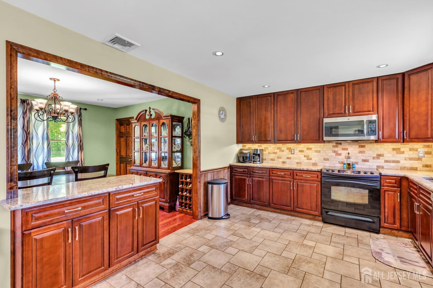 99 Schulmeister Road Old Bridge, NJ 08857 - Photo 6 of 49 a large kitchen with stainless steel appliances granite countertop a stove sink and cabinets