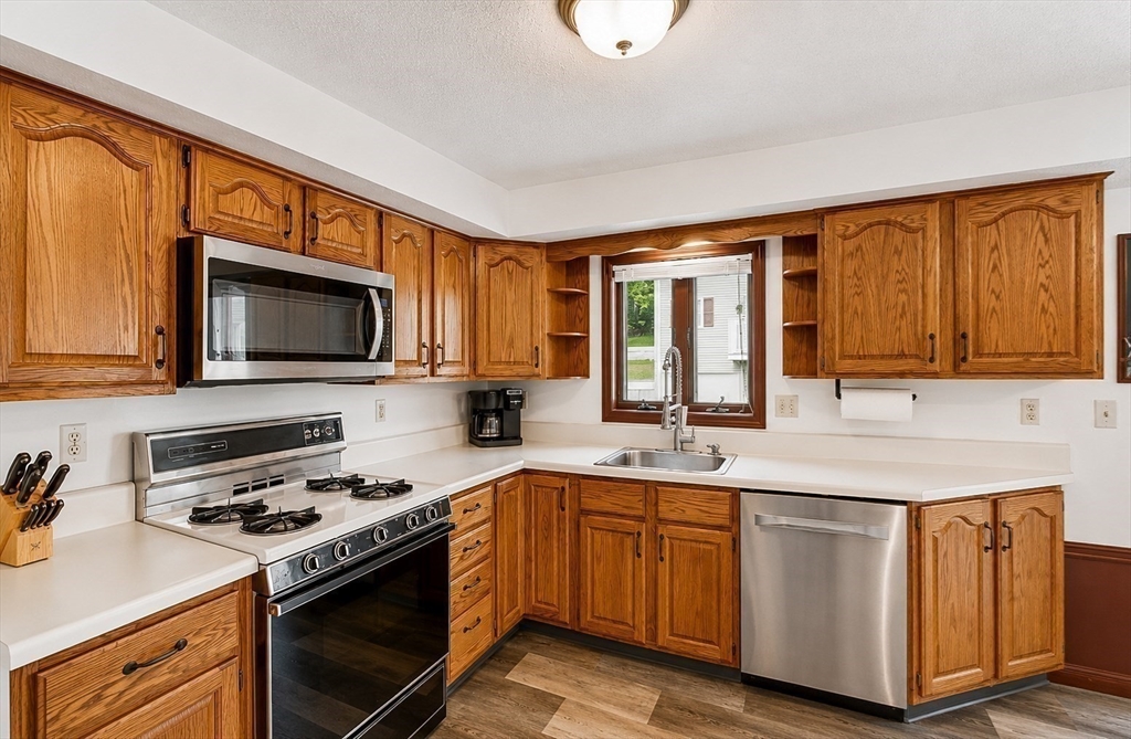 53 Century Way, Unit 53 Gardner, MA 01440 - Photo 9 of 22 a kitchen with a sink stove and microwave