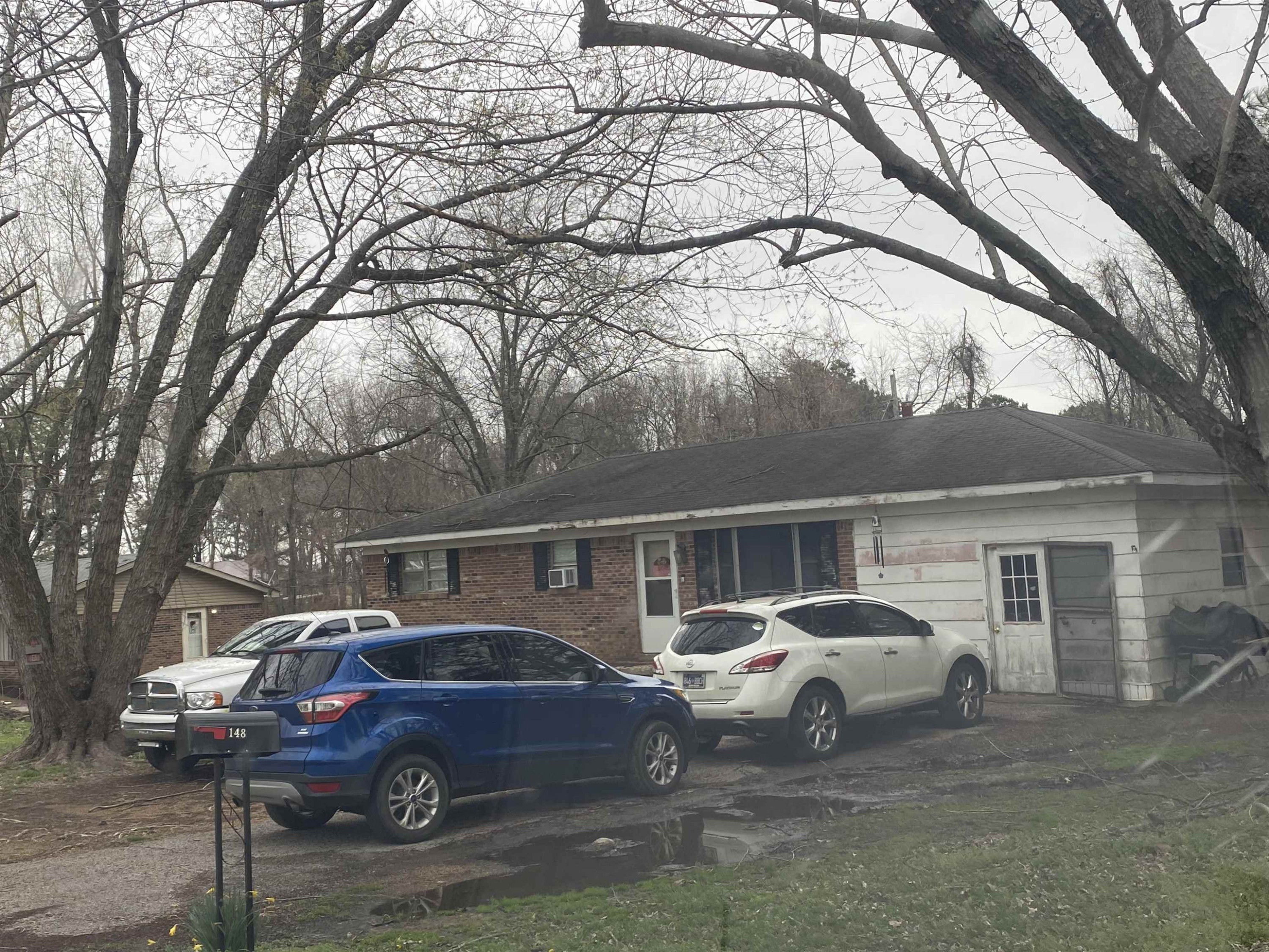 a view of a cars park in front of a house