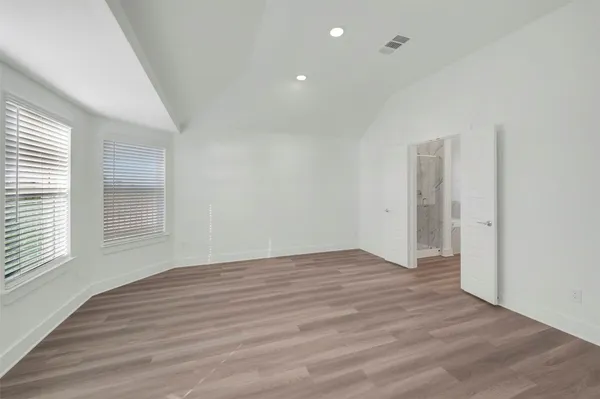 a view of a room with wooden floor