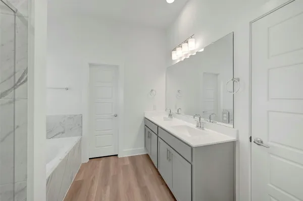 a bathroom with a sink a mirror and a shower