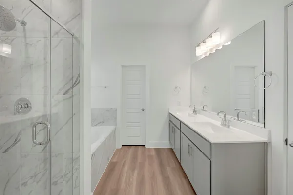 a bathroom with a double vanity sink and mirror