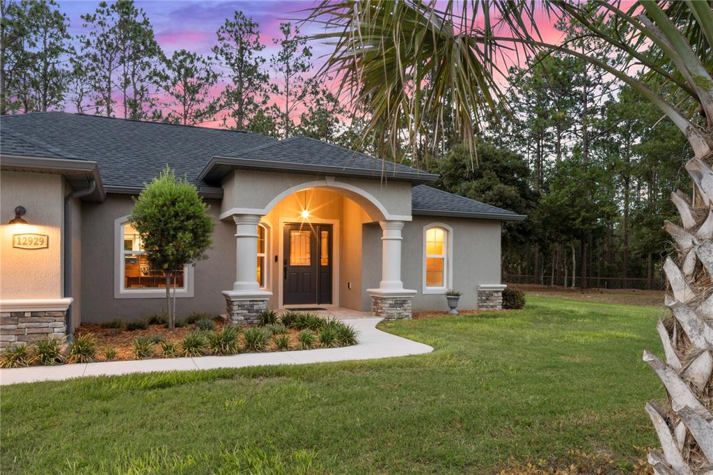 12929 Southwest 89th Street Dunnellon, FL 34432 - Photo 45 of 76 a view of a house with a swimming pool