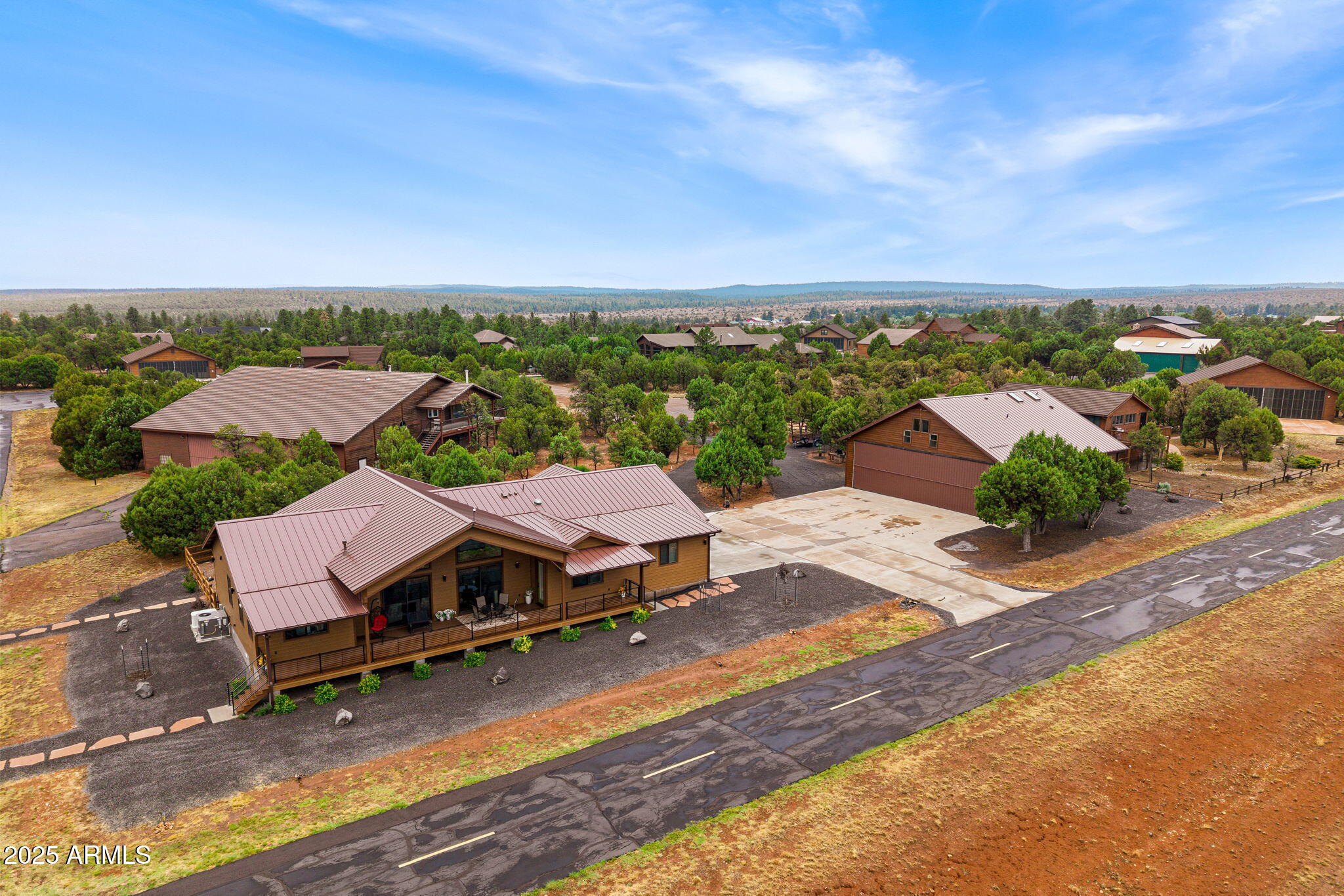 an aerial view of a houses with a big yard