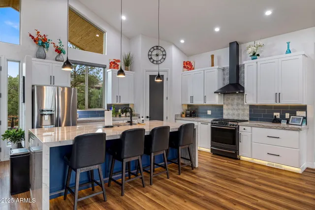 a kitchen with stainless steel appliances a stove and a cabinets