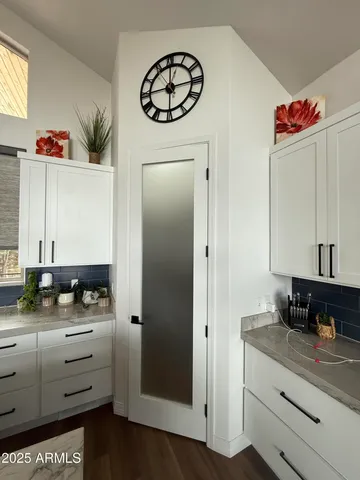 a kitchen with granite countertop a sink a stove and cabinets