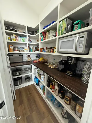 a bedroom with a bed a couch and dresser