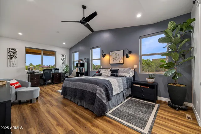 a bedroom with a bed and a flat screen tv