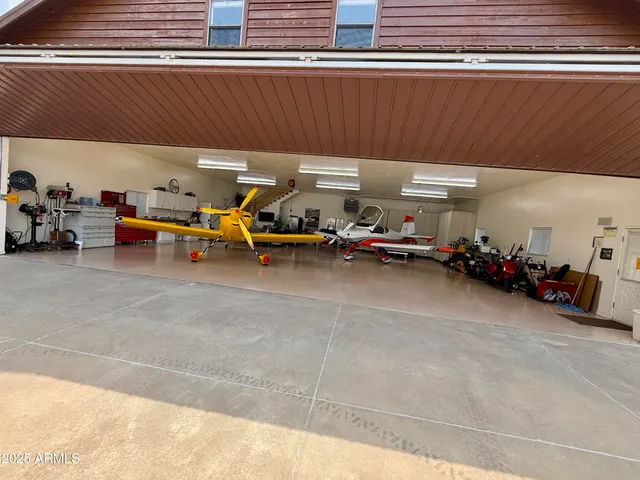 a bedroom with furniture and a wooden floor