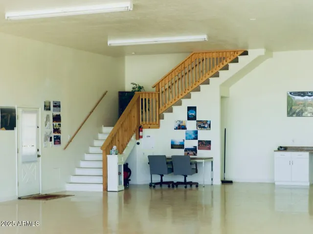 a view of a patio with table and chairs and potted plants