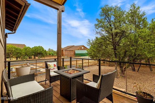 a view of a balcony with wooden floor and outdoor seating