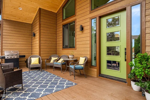 a living room with furniture ceiling fan and a flat screen tv