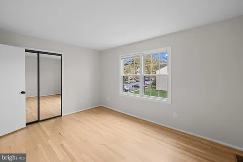 an empty room with windows and closet
