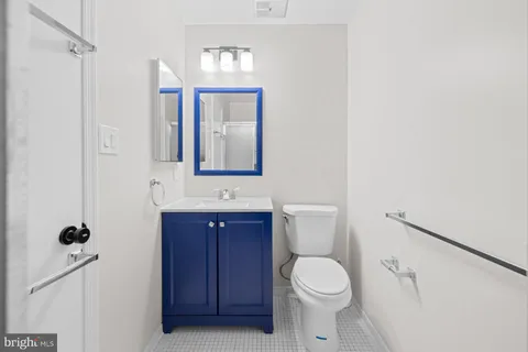 a bathroom with a toilet a sink and mirror