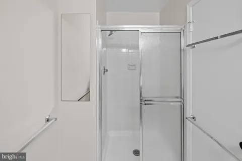 a bathroom with a glass shower door