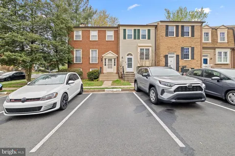 a view of a cars park in front of a building