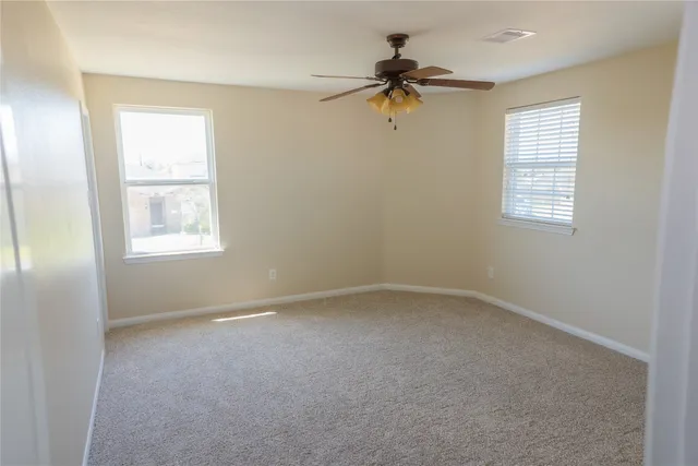 a view of empty room with windows