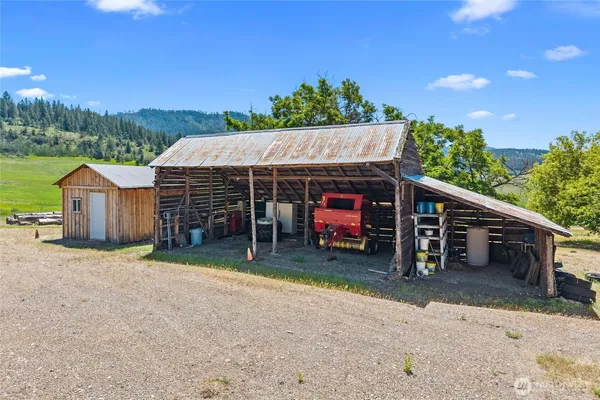 a view of a house with a backyard and a car