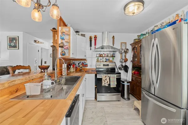 a kitchen with refrigerator and cabinets