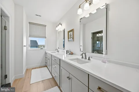 a bathroom with a granite countertop toilet and a sink