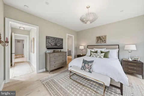 a bedroom with a bed and a chandelier