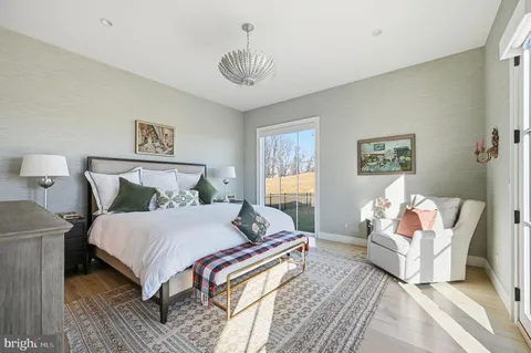 a large bedroom with a bed and a large window
