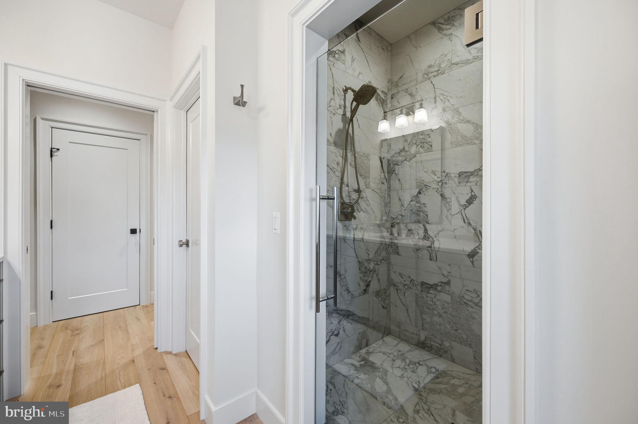 604 Martingale Ridge Drive Middleburg, VA 20117 - Photo 34 of 53 Elegant marble shower in a modern hallway.