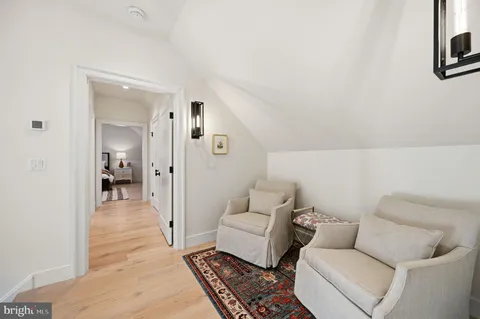 a bed room with a bed and a chair