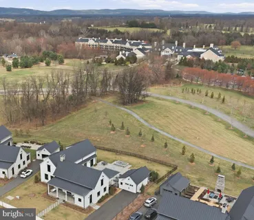 an aerial view of a house with a lake view