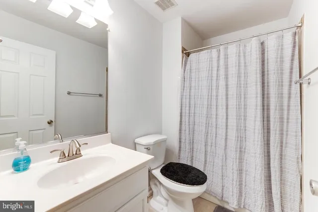 a kitchen with a sink a refrigerator a microwave and cabinets