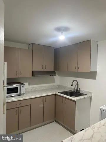a kitchen with cabinets appliances and a sink