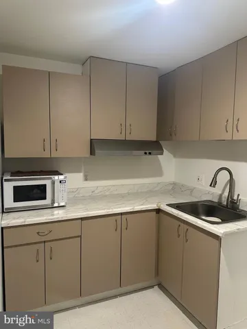 a kitchen with cabinets and stainless steel appliances