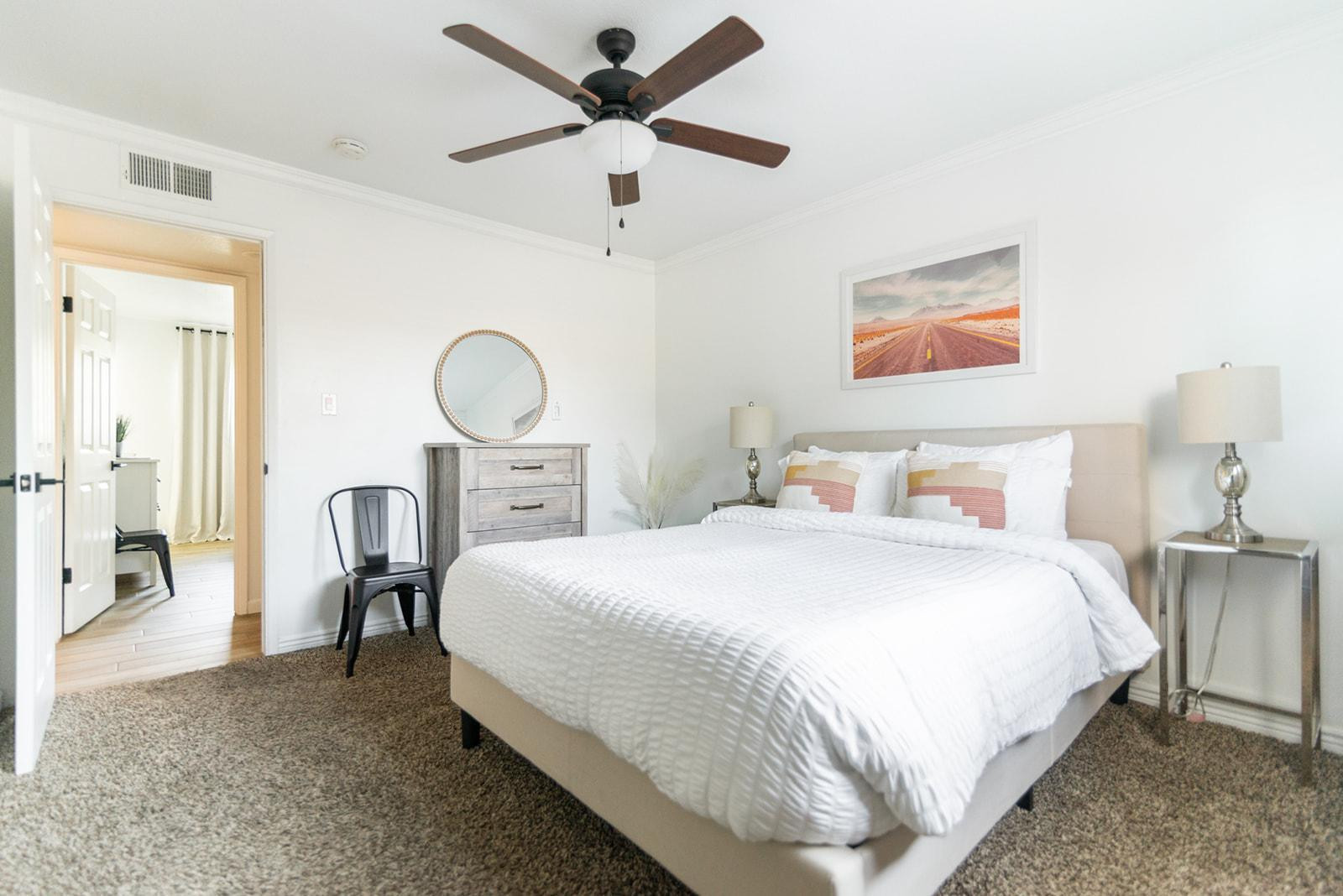 7435 East Granada Road Scottsdale, AZ 85257 - Photo 23 of 28 a bedroom with bed and a chandelier