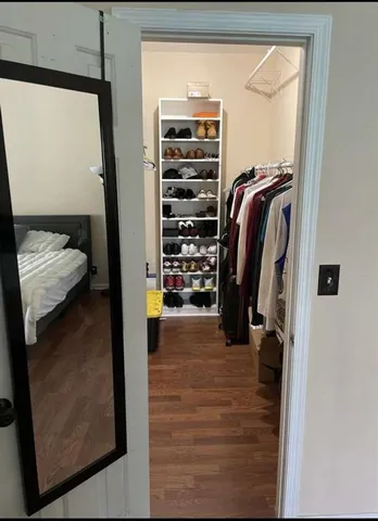 a bedroom with a bed and wooden floor