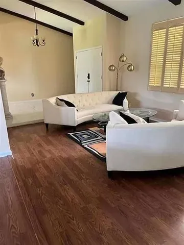 a view of hallway with stairs and chandelier