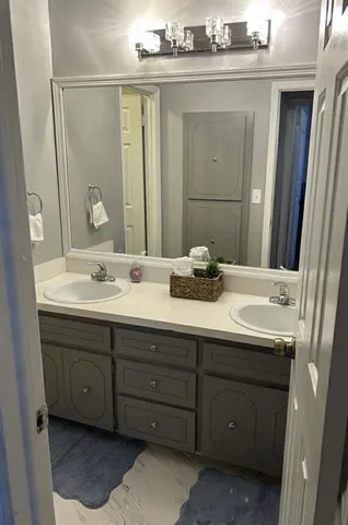 a bathroom with a double vanity sink and mirror