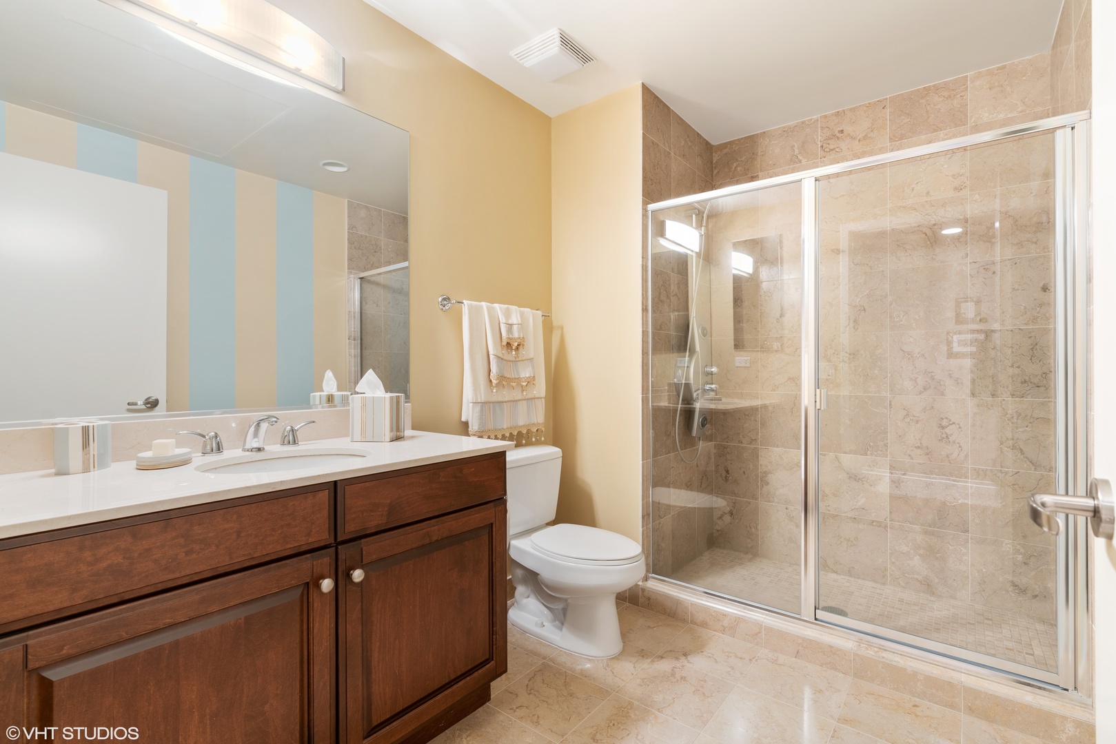 310 South Michigan Avenue, Unit 1010 Chicago, IL 60604 - Photo 11 of 15 a bathroom with a shower sink vanity mirror and toilet