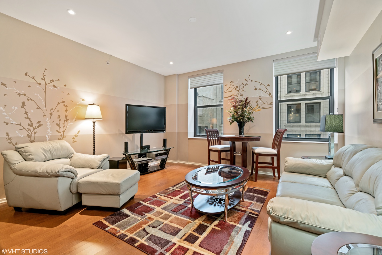 310 South Michigan Avenue, Unit 1010 Chicago, IL 60604 - Photo 3 of 15 a living room with furniture and a flat screen tv