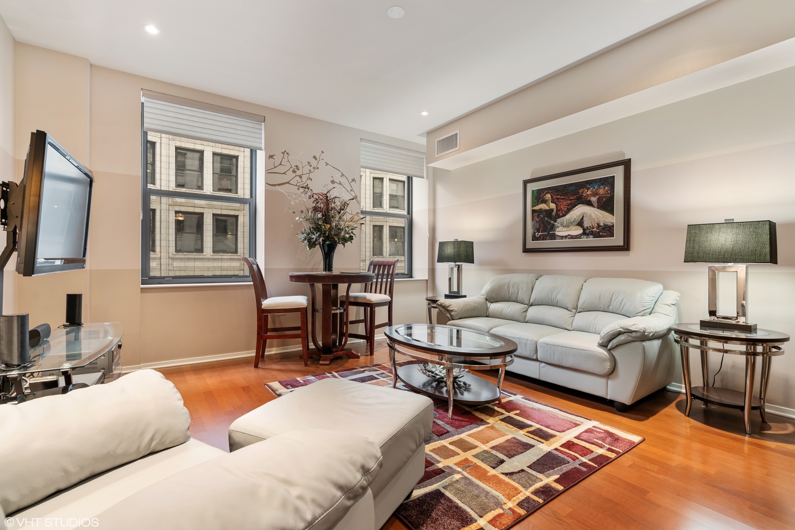 310 South Michigan Avenue, Unit 1010 Chicago, IL 60604 - Photo 4 of 15 a living room with furniture and a flat screen tv