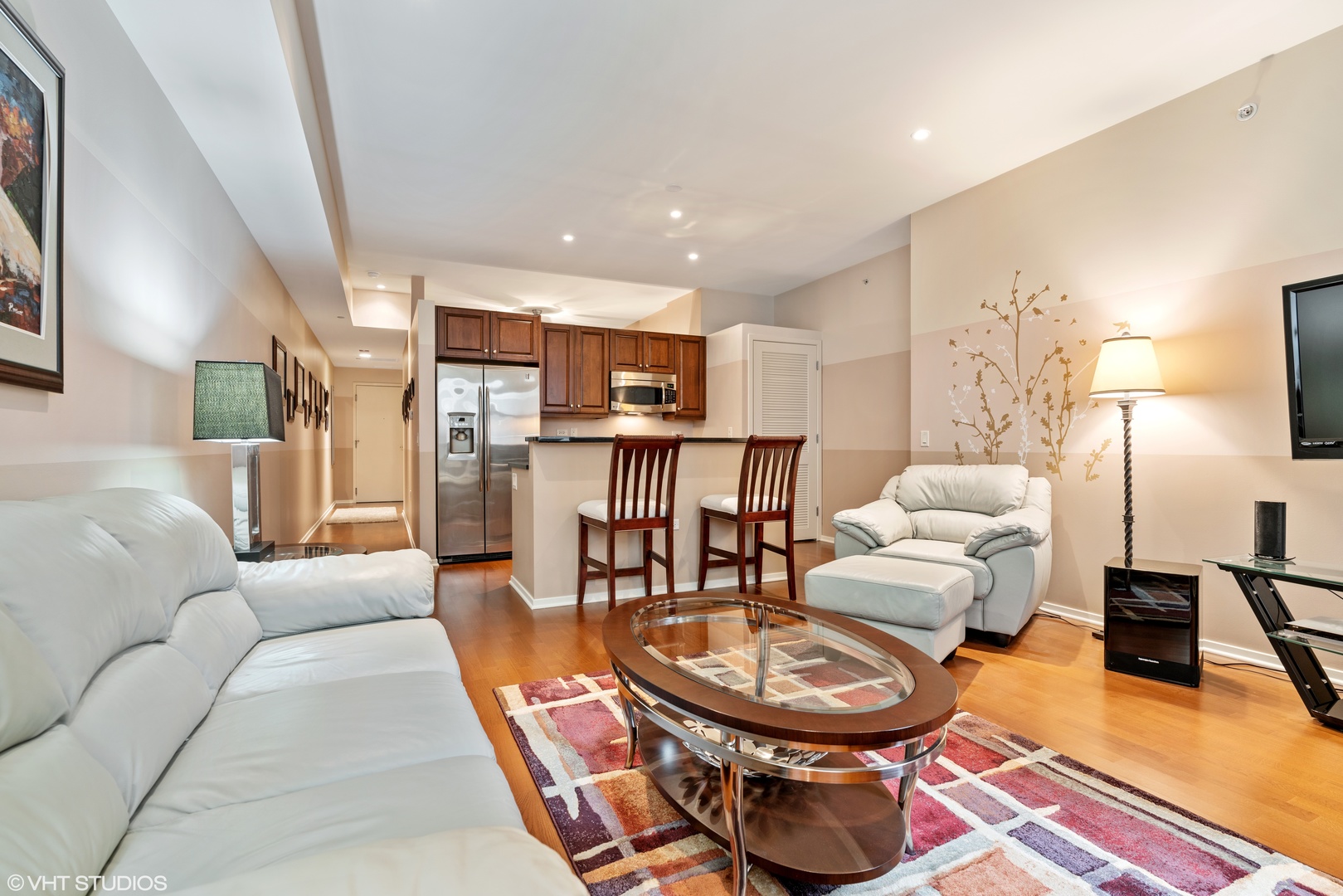 310 South Michigan Avenue, Unit 1010 Chicago, IL 60604 - Photo 6 of 15 a living room with furniture and a wooden floor