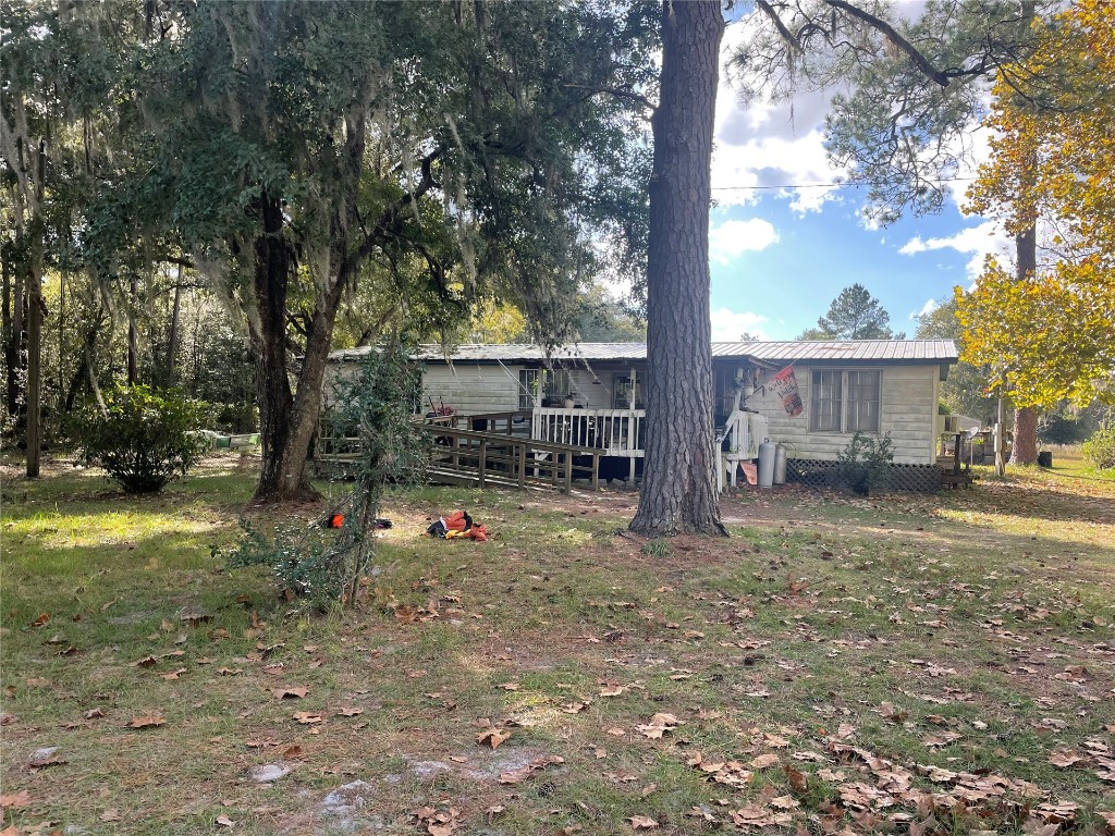 15206 Howard Road Bryceville, FL 32009 - Photo 3 of 13 a view of house with backyard space and garden