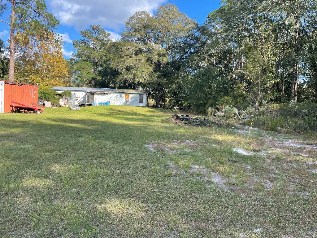 15206 Howard Road Bryceville, FL 32009 - Photo 6 of 13 a front view of a house with a yard