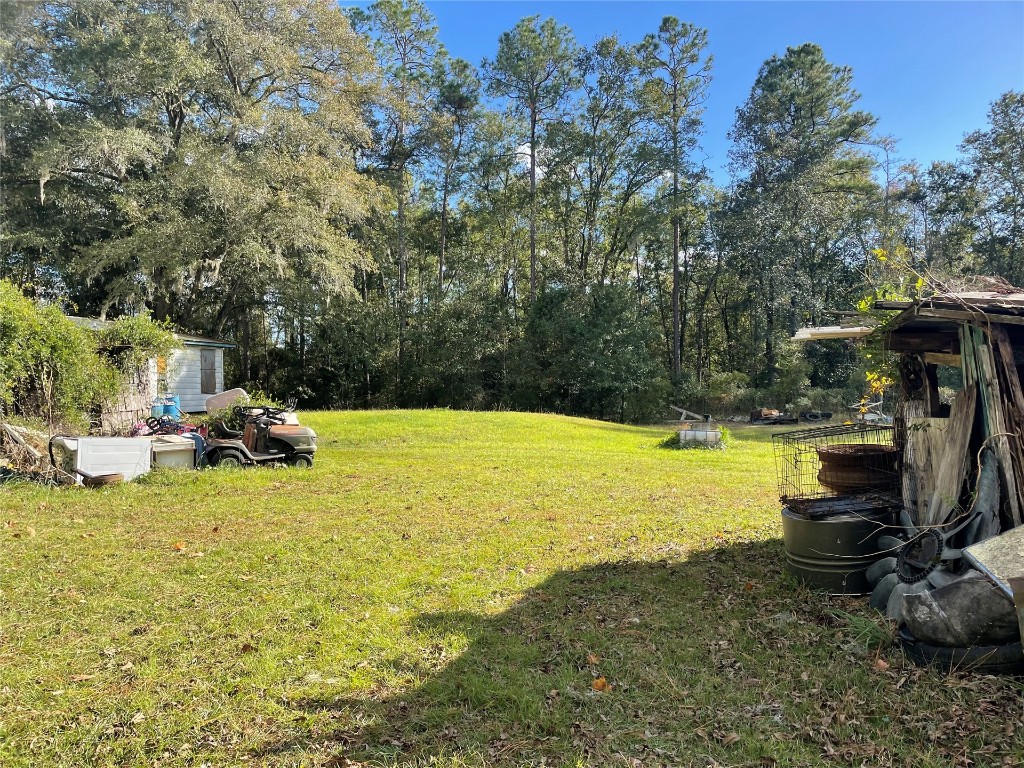 15206 Howard Road Bryceville, FL 32009 - Photo 8 of 13 a view of a swimming pool and lounge chairs