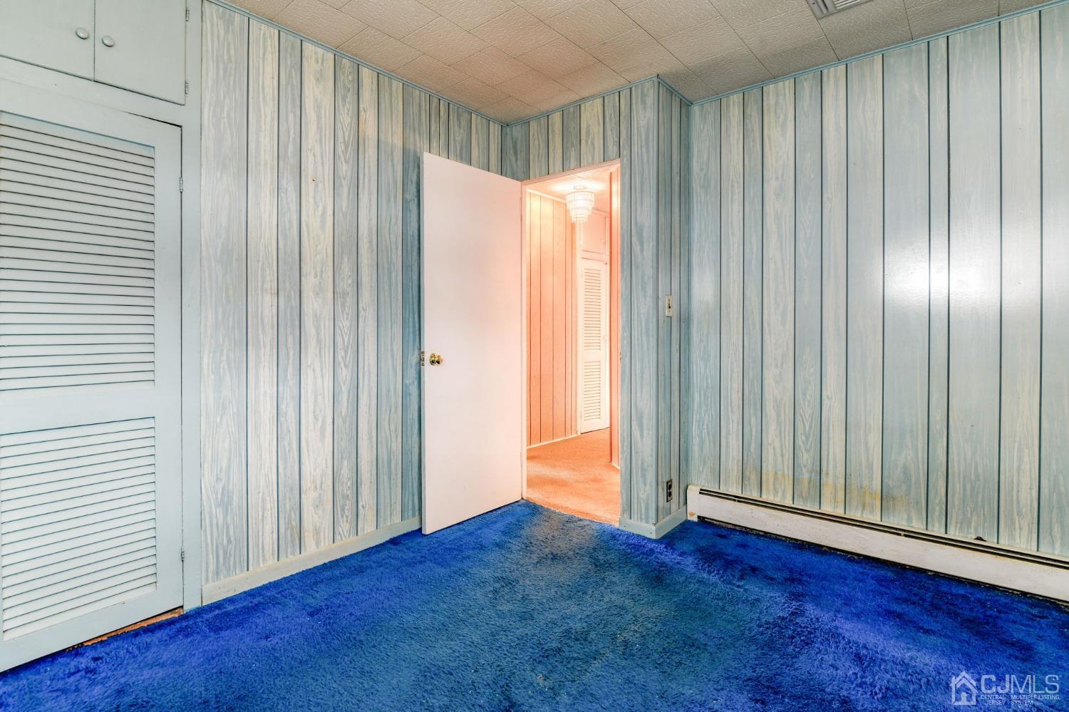 22 Parkerson Road Edison, NJ 08817 - Photo 17 of 29 an empty room with wooden floor and windows with curtains