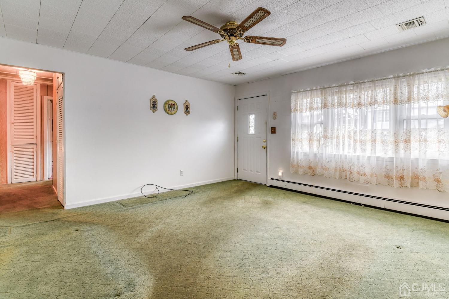 22 Parkerson Road Edison, NJ 08817 - Photo 6 of 29 an empty room with a empty space and windows