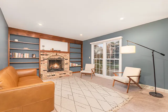 a living room with furniture and a fireplace